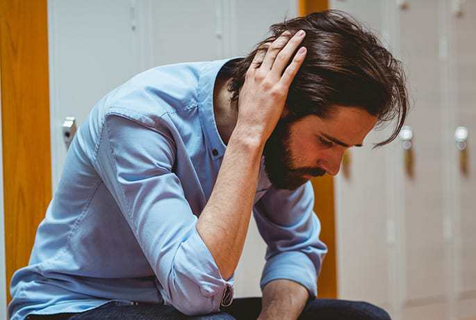 Man with hand on head worried about someone