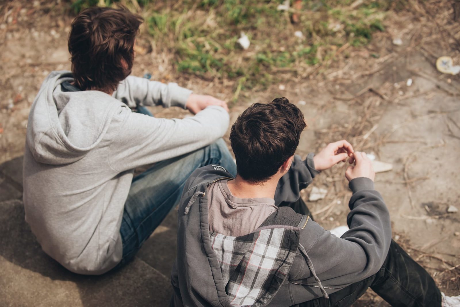 Two young men sitting together having a conversation about mental health