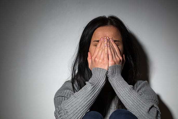 Women upset with head in hands