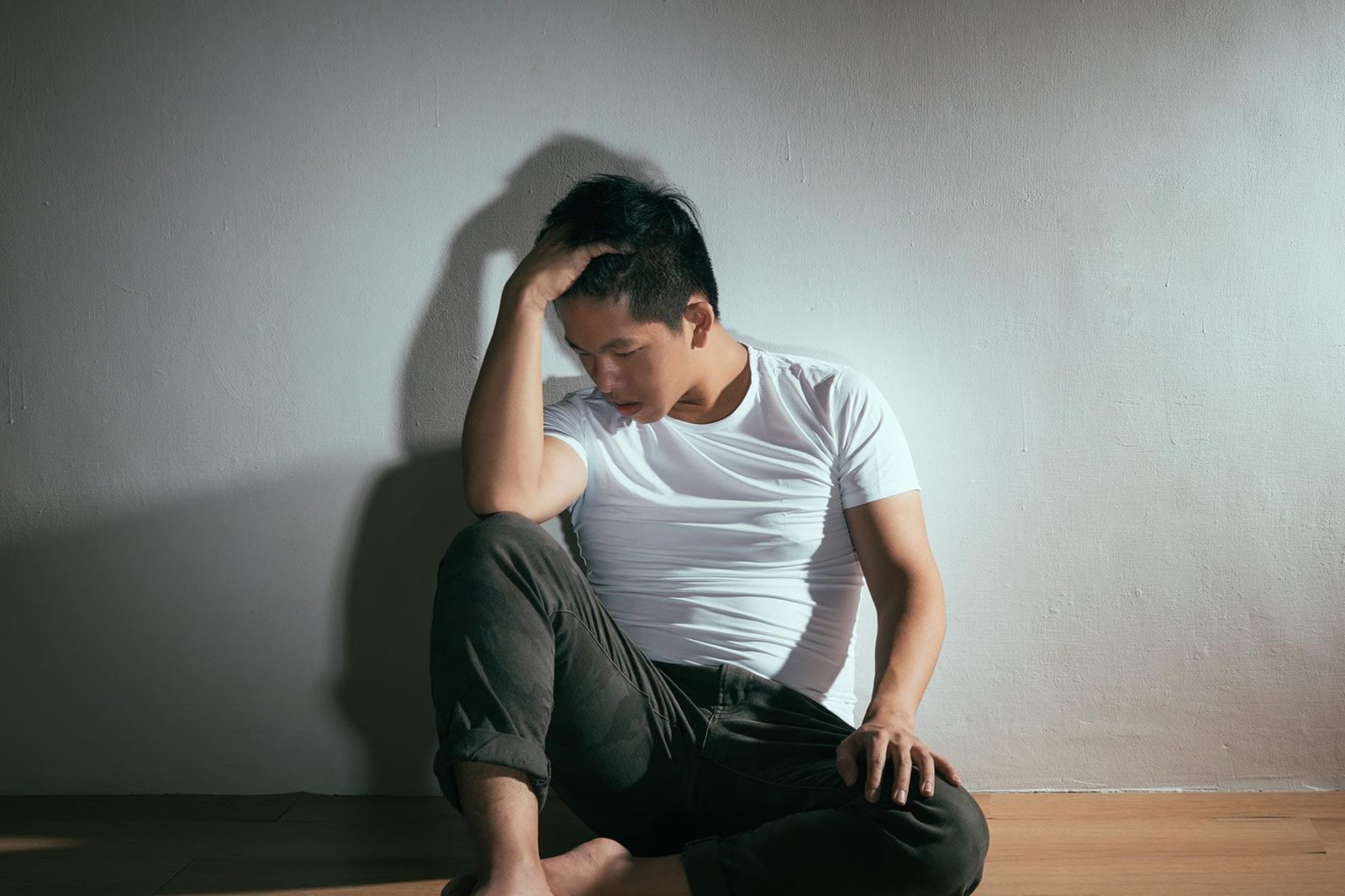 Self-harm: Man sitting on the floor