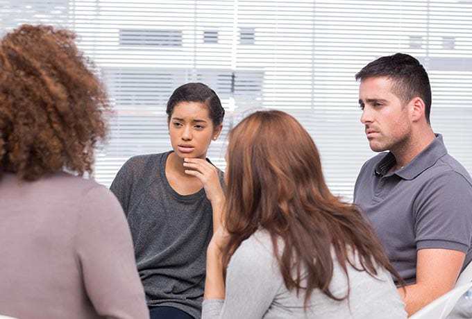 People in a support group mourning the loss of someone by suicide