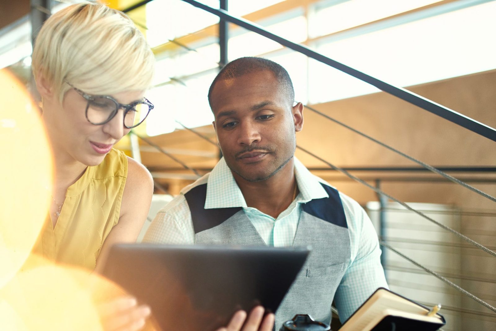 Two employees discussing work in an office