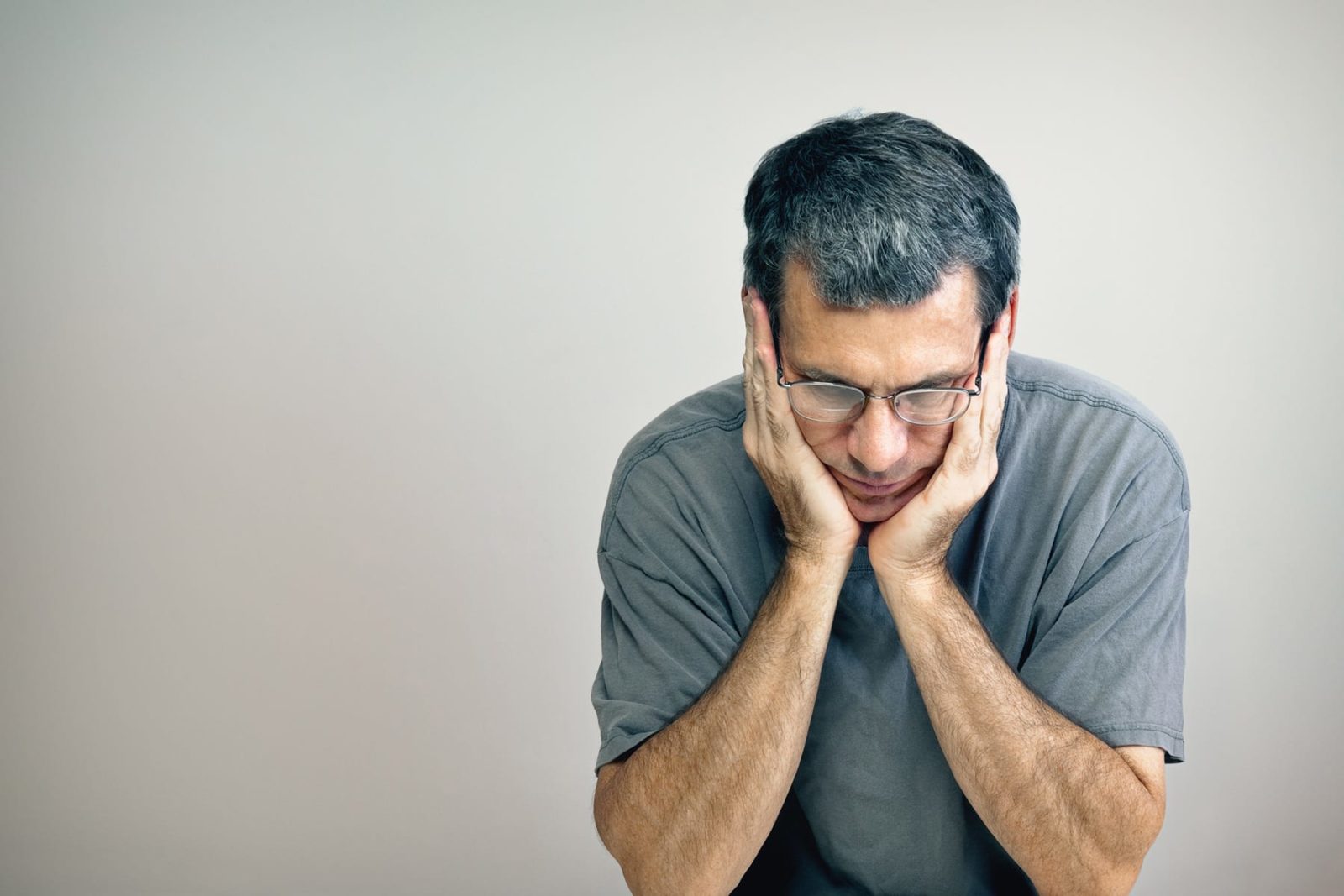 Man with head in hands having thoughts about ending his life