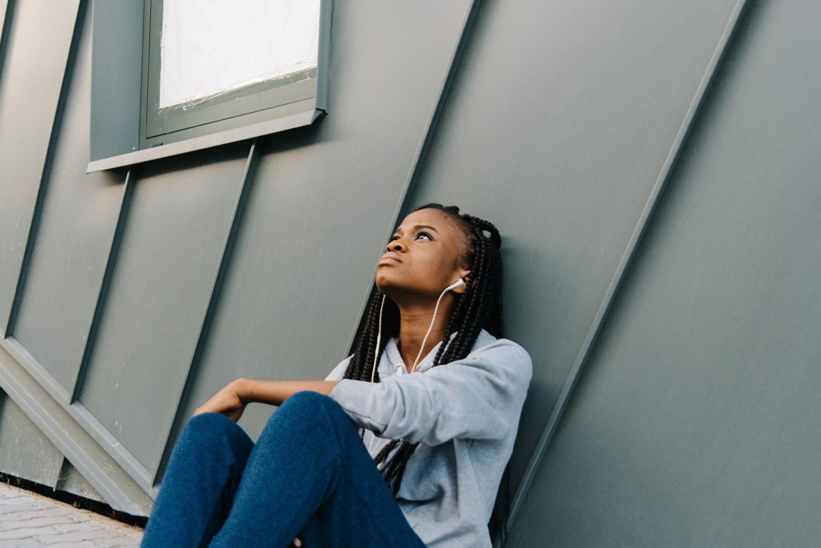 Women sat against a wall feeling suicidal