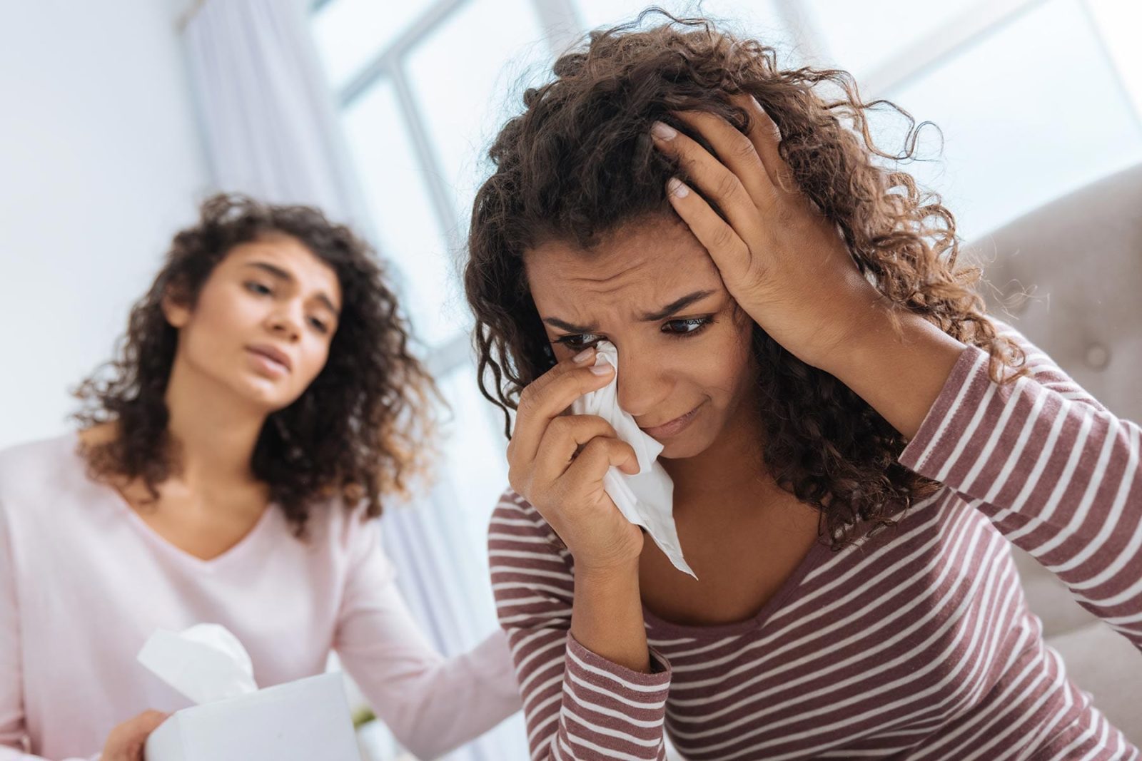 Women comforting her friend who is struggling