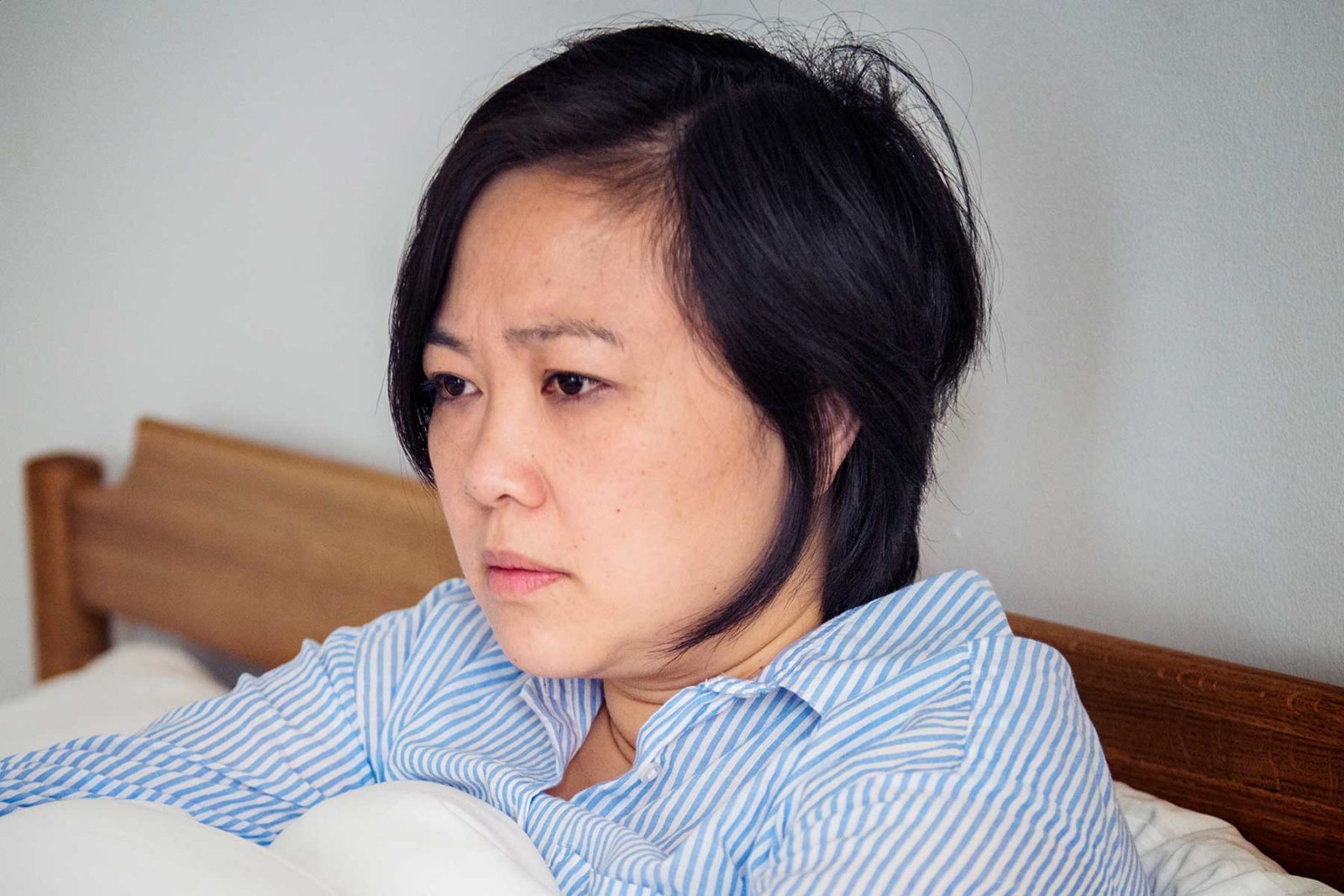 Women in bed suffering from depressed symptoms