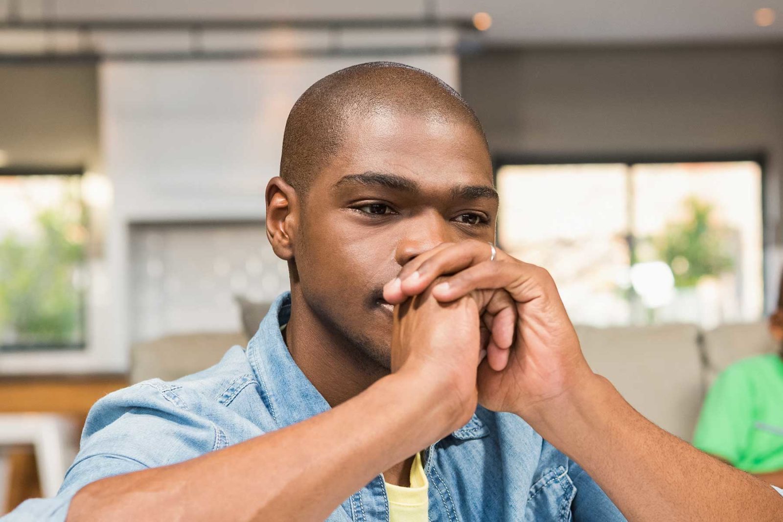 Man sat asking himself what are the causes of anxiety