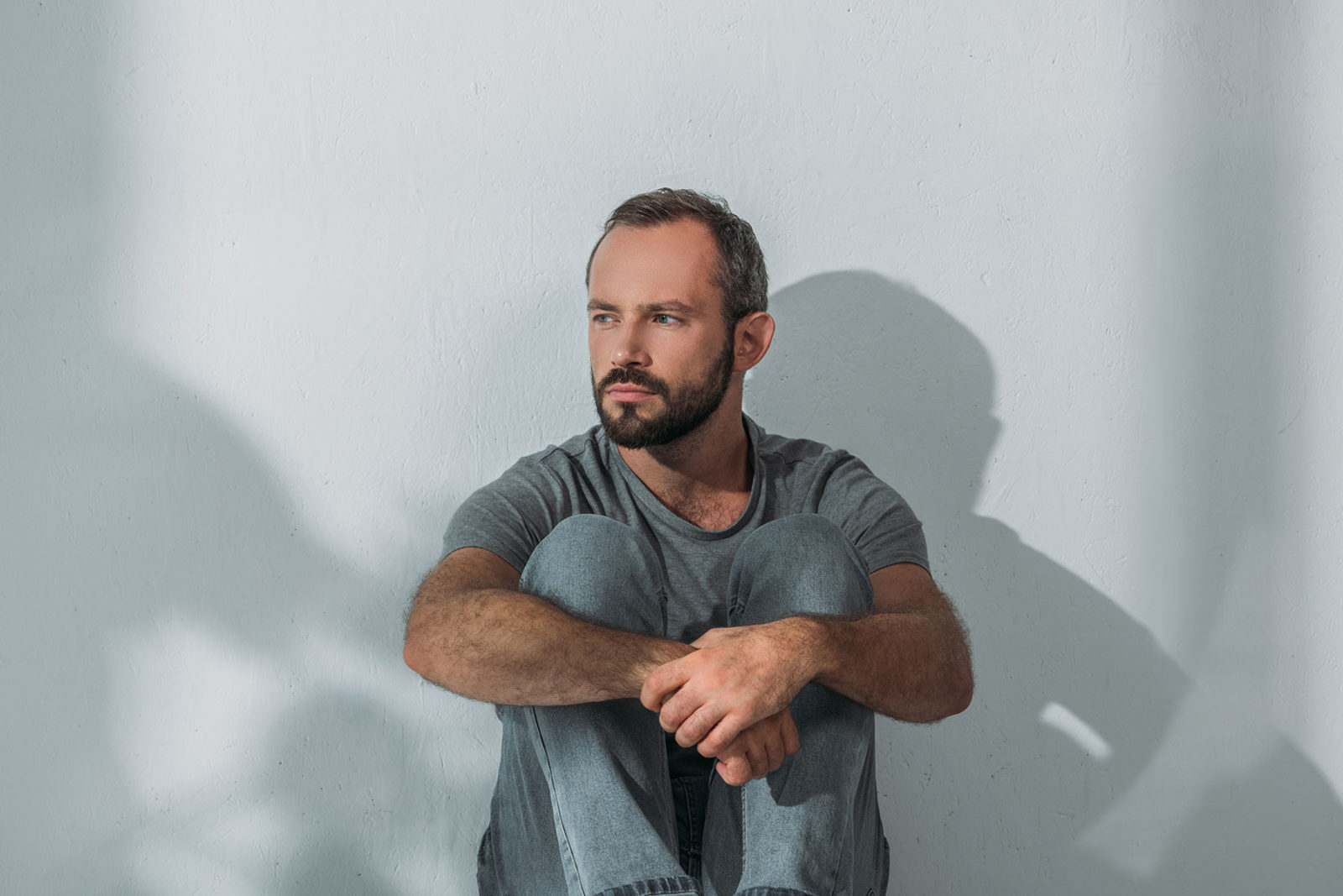 Man sitting alone experiencing domestic violence