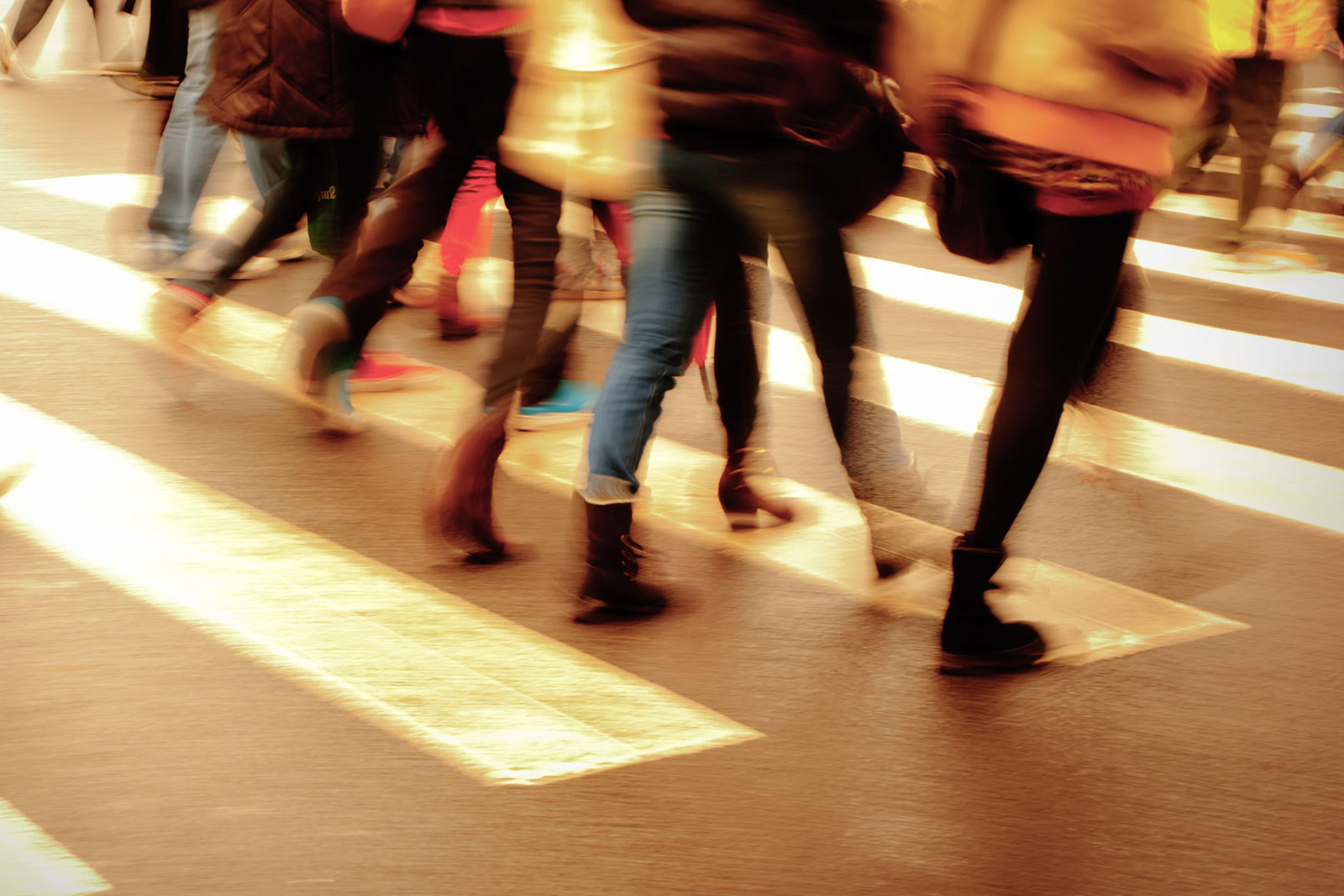 People walking across a busy street
