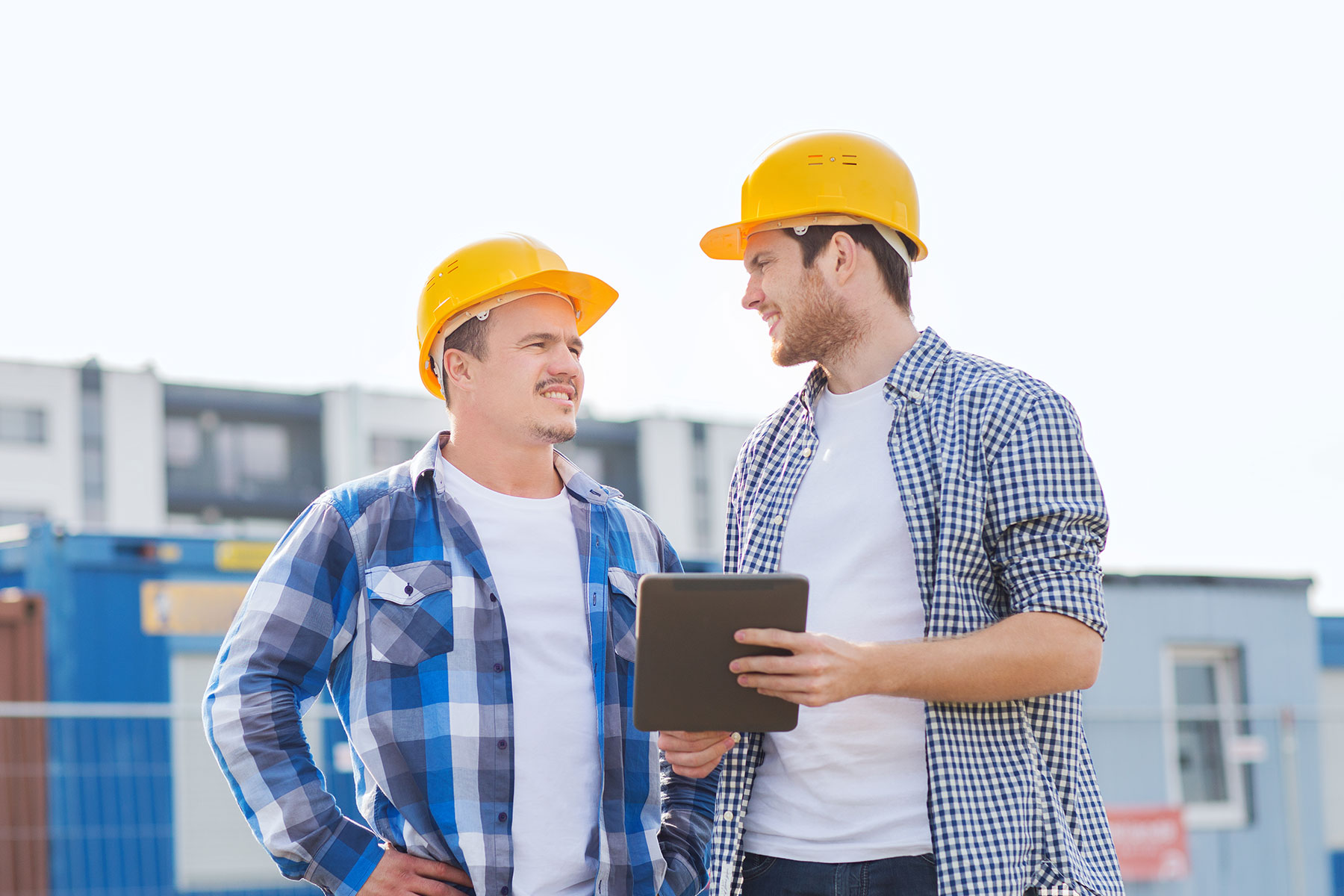 Two men on a building site talking