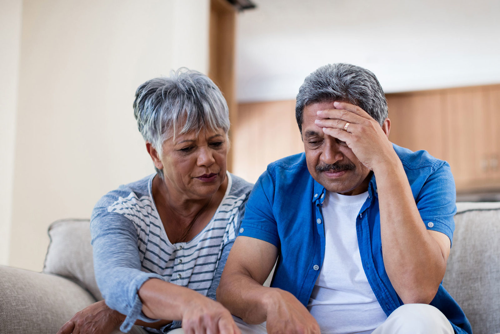 Couple sat together trying to cope after a large scale tragedy