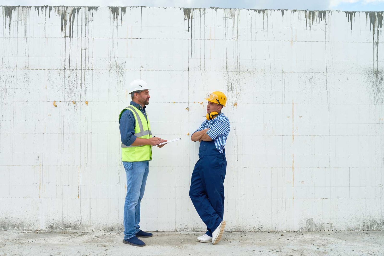 two work colleagues talking on a building site