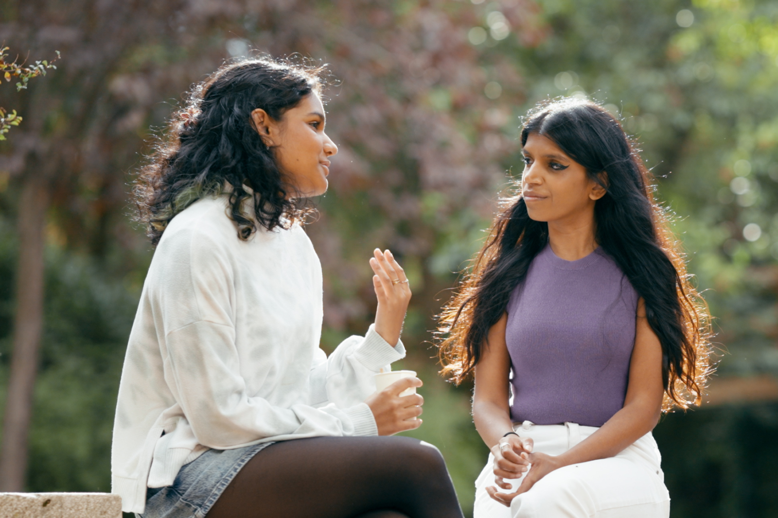 Two friends talking in a park