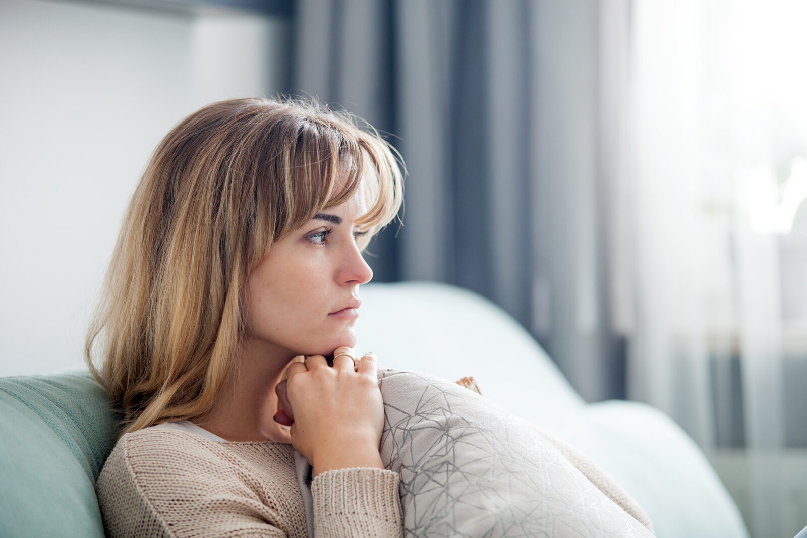 Woman sitting alone with worried expression