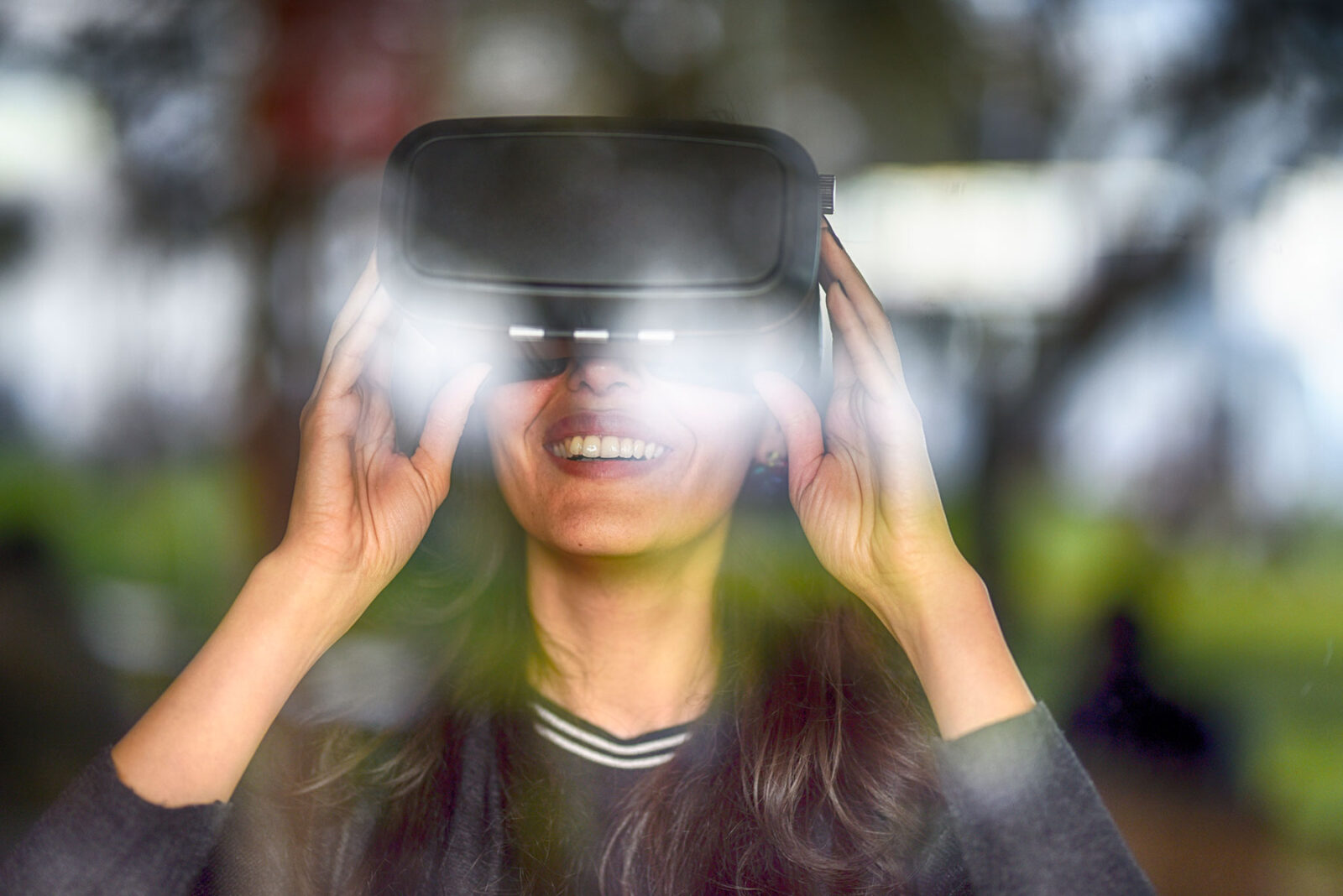 Women using virtual reality training headset smiling