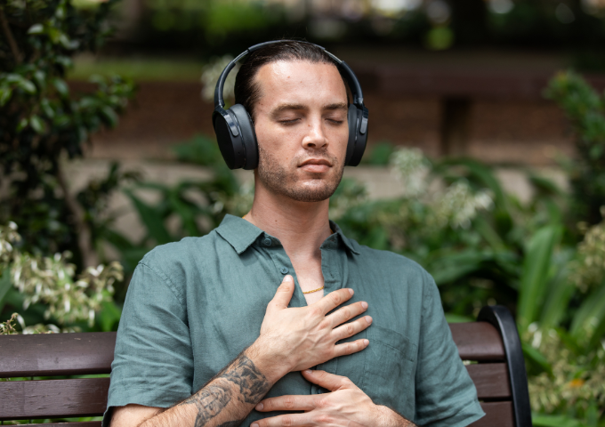 Man sitting in stillness with headphones on