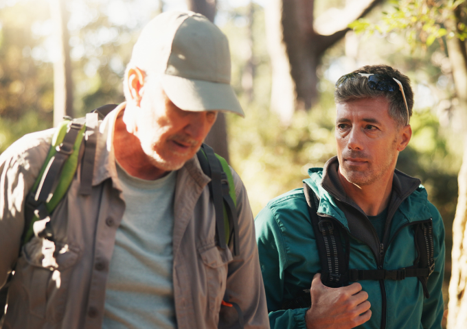 Two friends hiking in forest