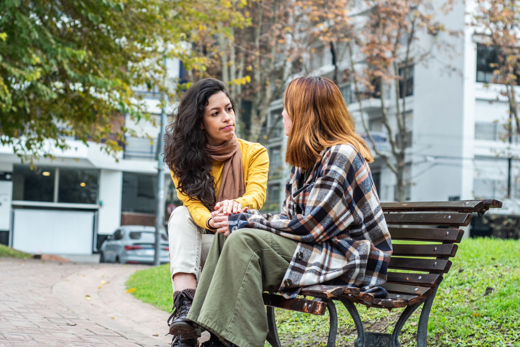 Friends sitting on a bench talking